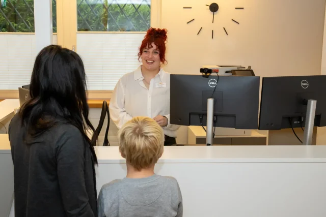 The medical secretary, Léane Sturzenegger, welcomes two patients.